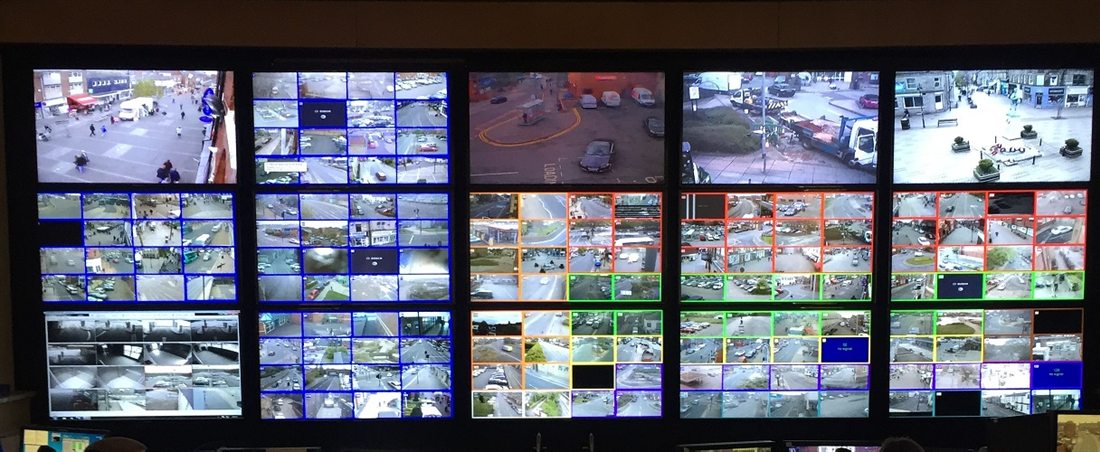 Muro de monitores de una sala de control de videovigilancia con decenas de cámaras en pantalla simultánea